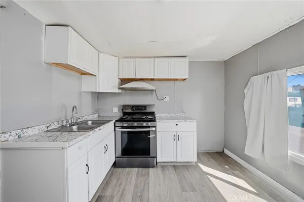 a kitchen with a sink stove and refrigerator