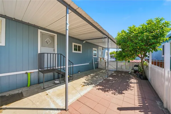 a view of a house with wooden fence