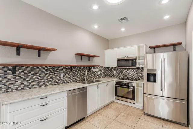 a kitchen with white cabinets