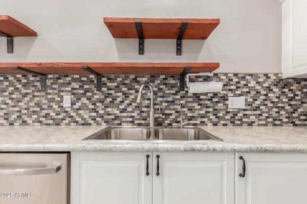 a kitchen with stainless steel appliances a refrigerator sink and microwave