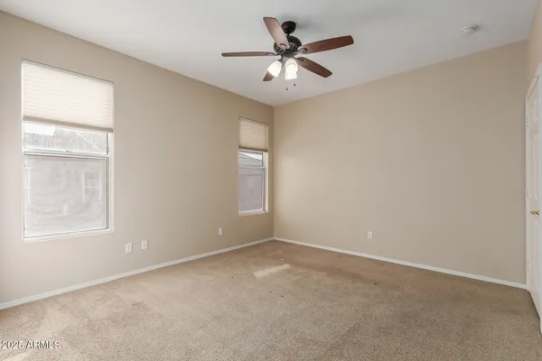 an empty room with a empty space and windows