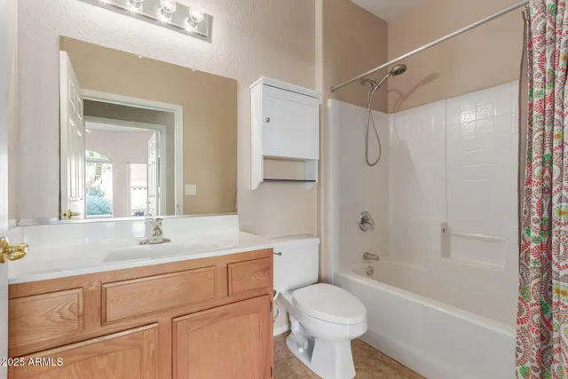 a bathroom with a shower curtain and a toilet