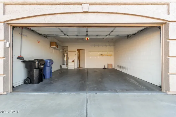 a view of a hallway with wooden floor and a ceiling fan