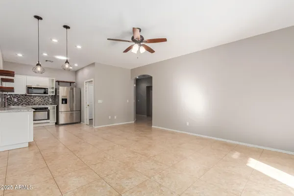 a view of an empty room with a cabinet and a flat screen tv
