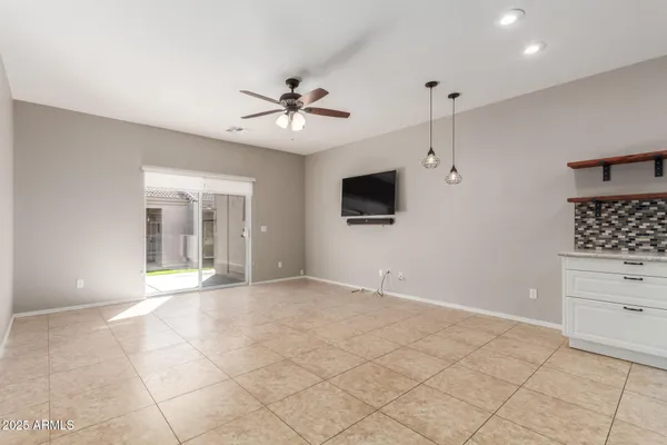 a view of an empty room with a window and a flat screen tv