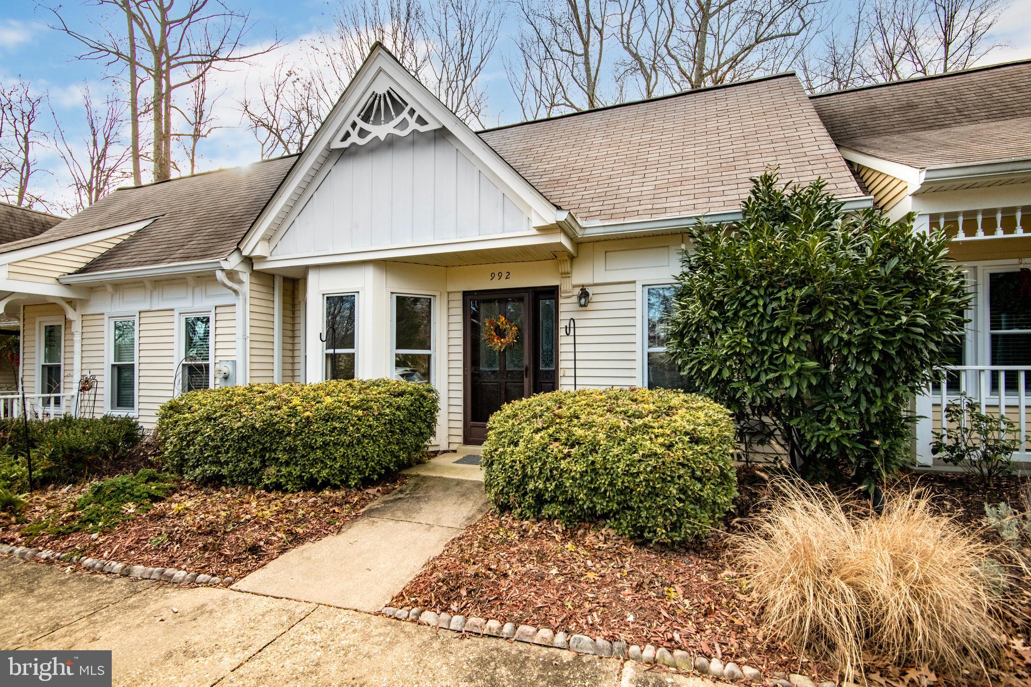 a view of a white house next to a yard