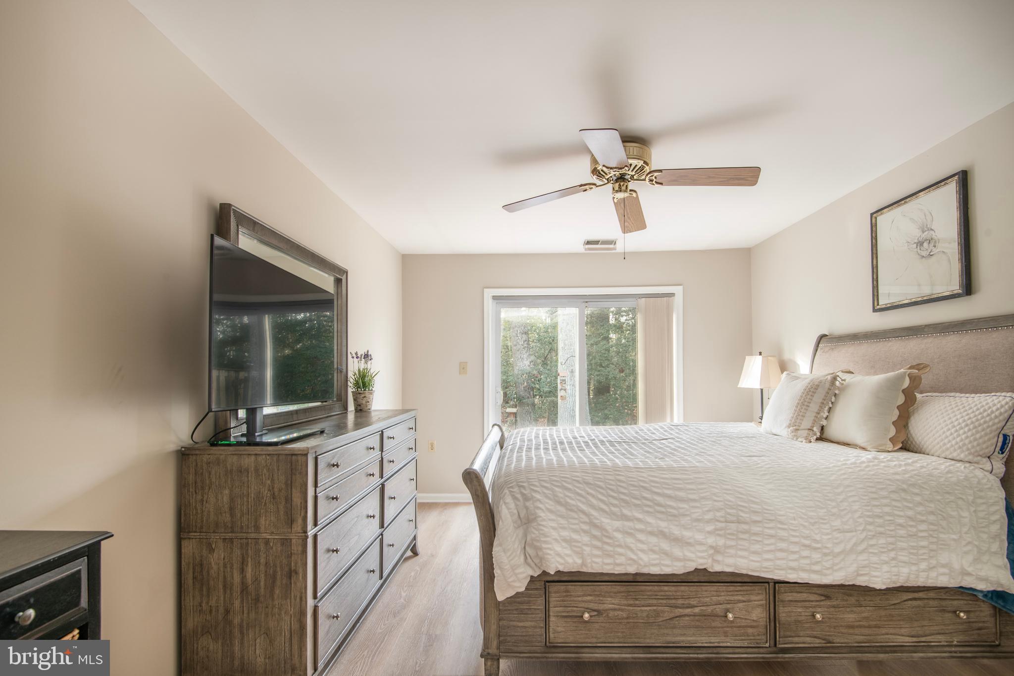 992 Riversedge Circle Annapolis, MD 21401 - Photo 22 of 35 a bedroom with a bed and a chandelier