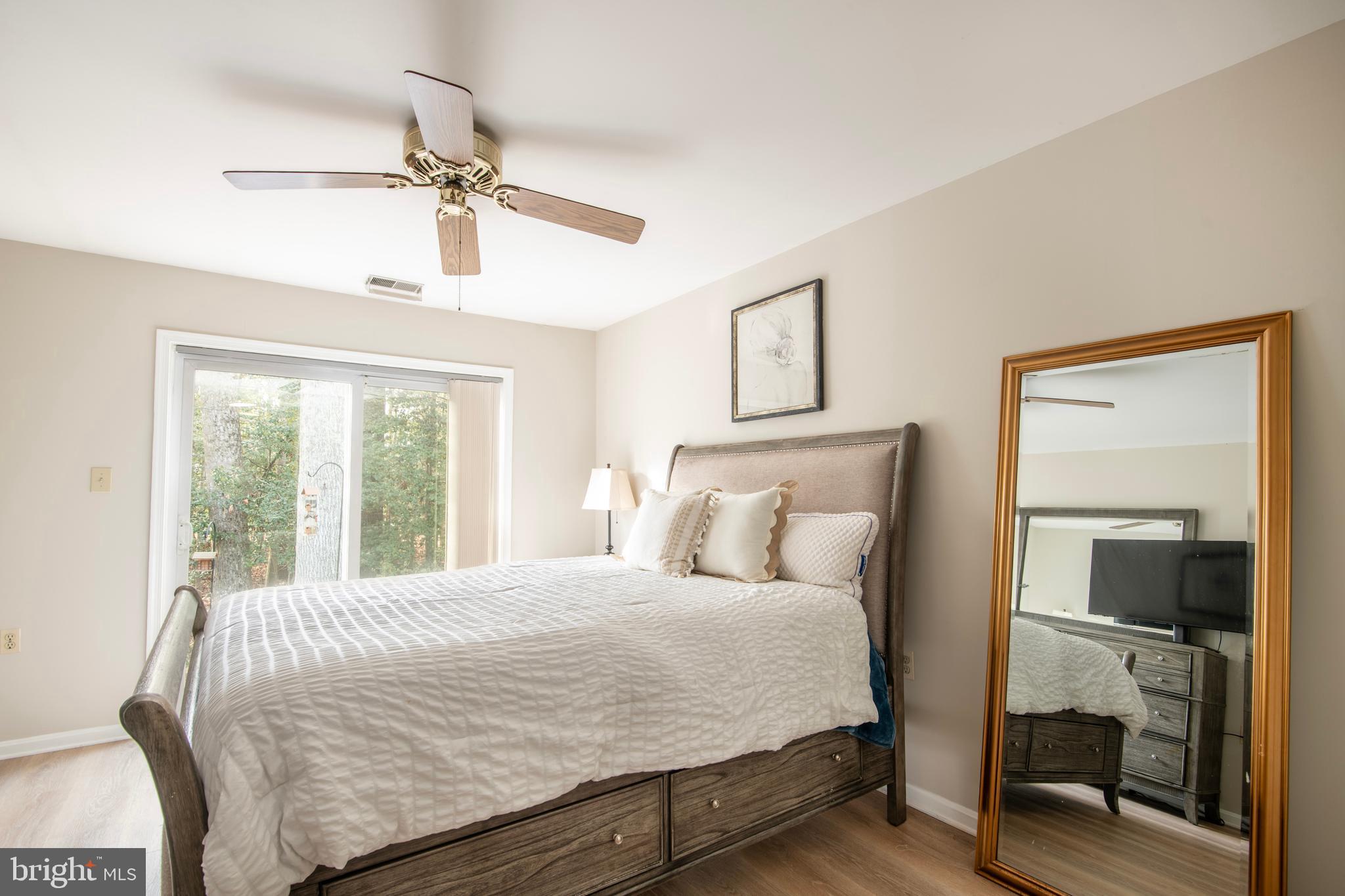 992 Riversedge Circle Annapolis, MD 21401 - Photo 24 of 35 a bedroom with a large bed and a chandelier