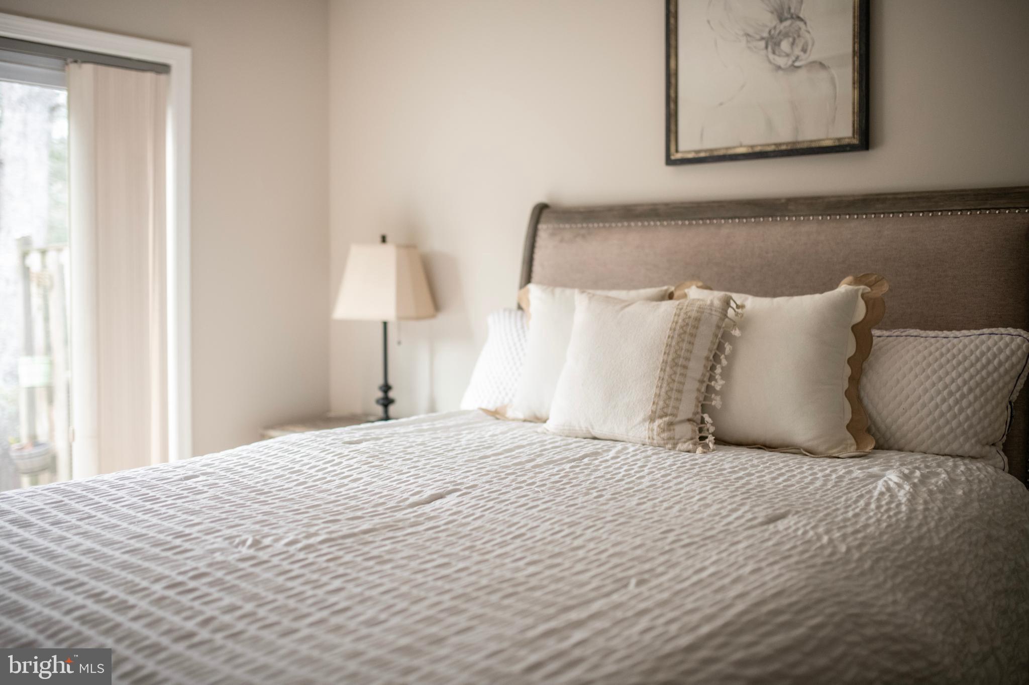 992 Riversedge Circle Annapolis, MD 21401 - Photo 25 of 35 a large bed sitting in a bedroom next to a window