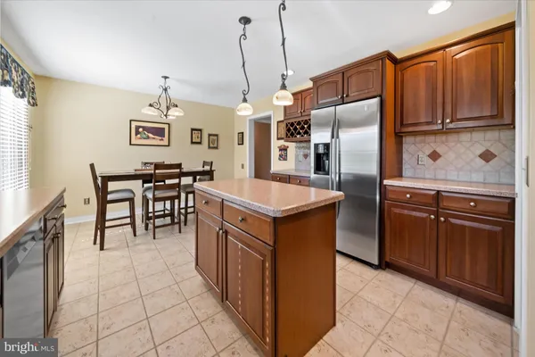 a kitchen with granite countertop a sink a counter top space appliances and cabinets