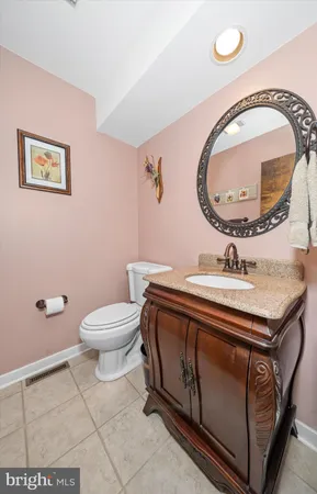 a bathroom with a sink mirror vanity and toilet