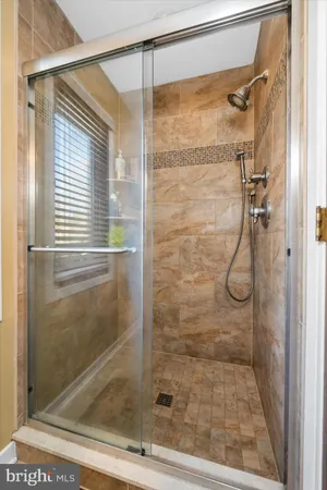 a bathroom with a glass shower door