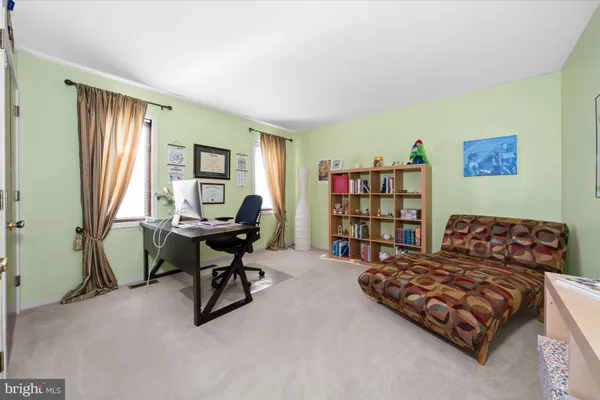 a bedroom with a bed and a bookshelf