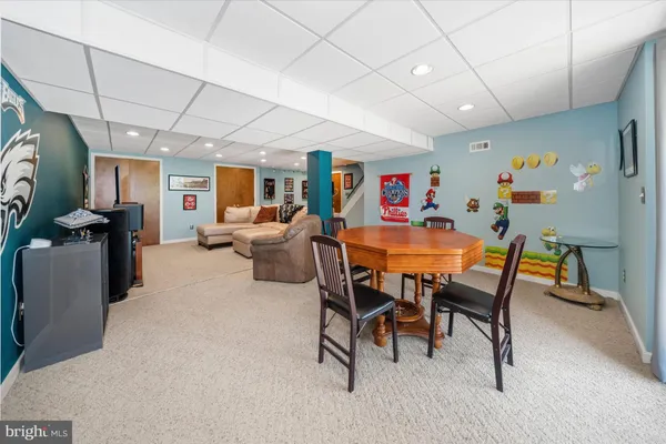 a dining room with furniture and a painting