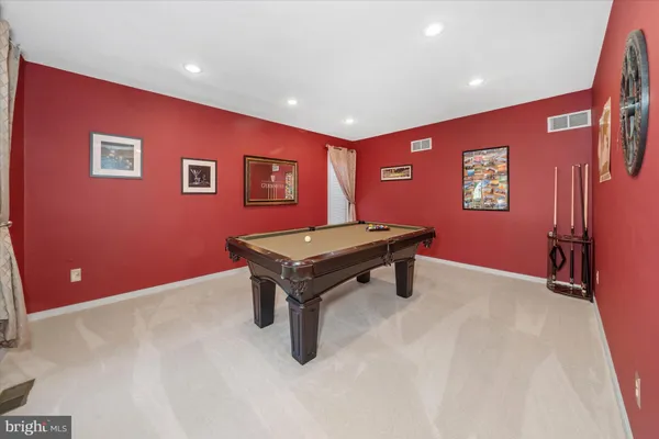 a room with pool table and wall paintings