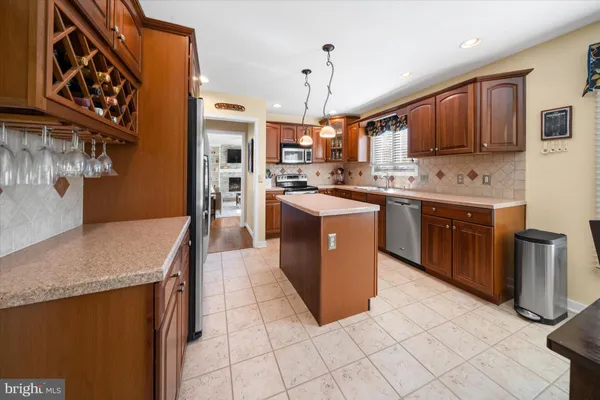 a kitchen with stainless steel appliances granite countertop a sink counter space cabinets and a stove