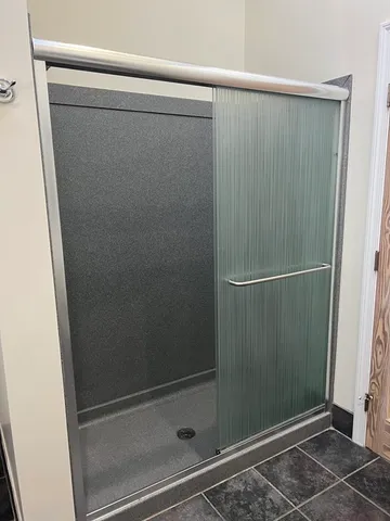 a bathroom with a glass shower door