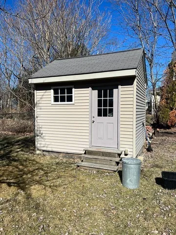 a backyard of a house with table and chairs