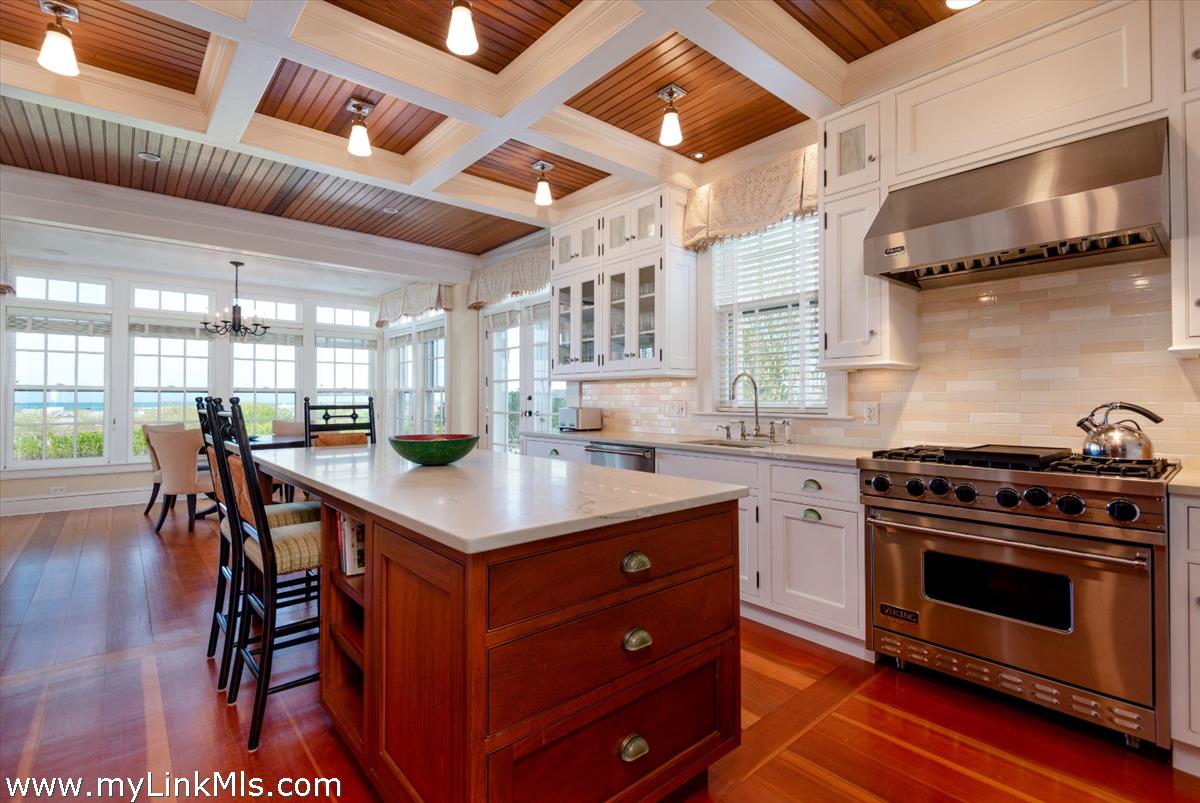 39 Cliff Road Nantucket, MA 02554 - Photo 16 of 46 a kitchen with a stove a table and chairs