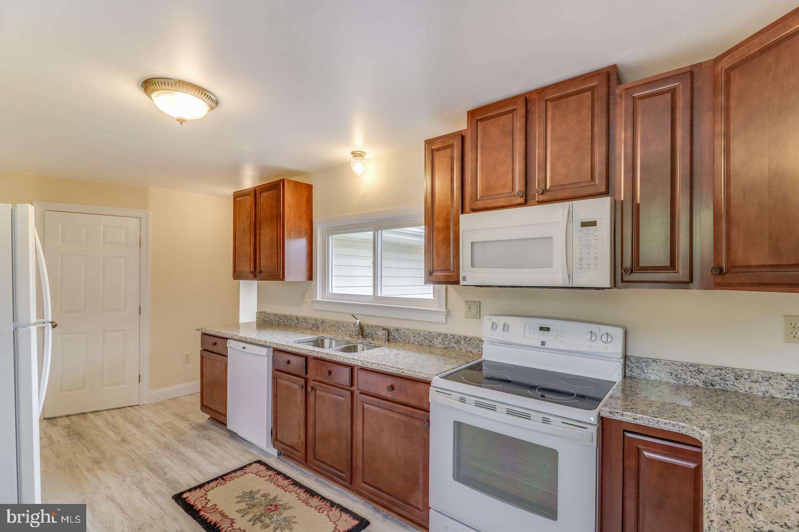 5868 Rock Hall Road Rock Hall, MD 21661 - Photo 7 of 39 Kitchen with luxury vinyl flooring and granite