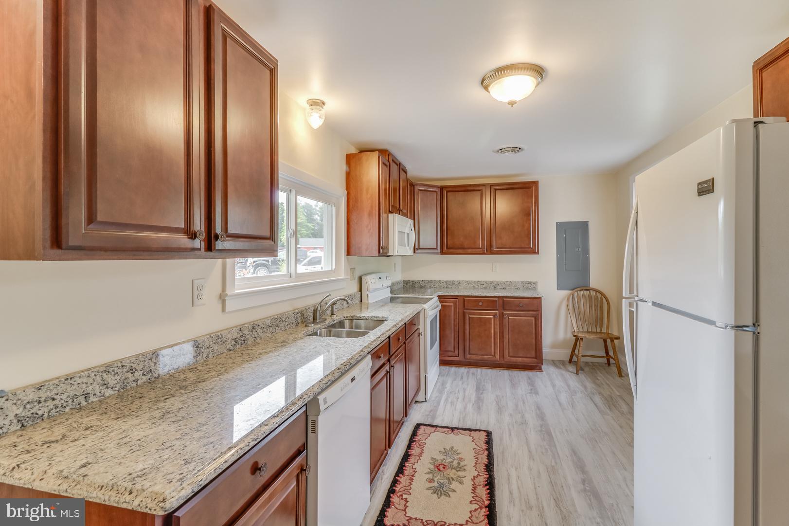 5868 Rock Hall Road Rock Hall, MD 21661 - Photo 8 of 39 Kitchen with luxury vinyl flooring and granite