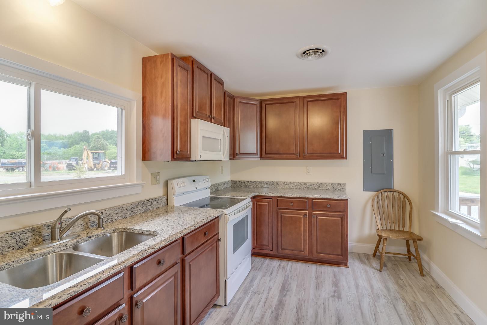 5868 Rock Hall Road Rock Hall, MD 21661 - Photo 9 of 39 Kitchen with luxury vinyl flooring and granite