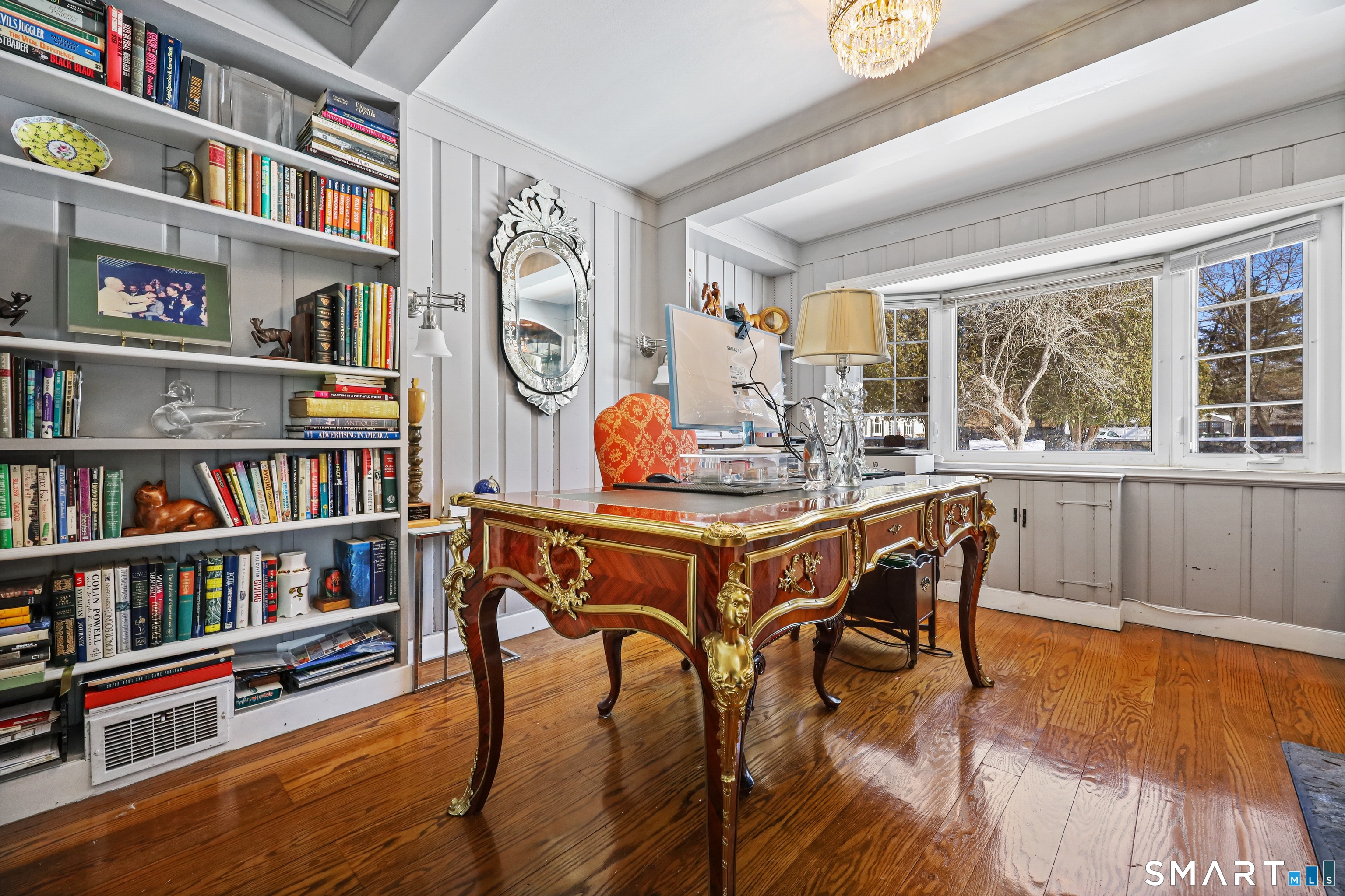 1209 Westover Road Stamford, CT 06902 - Photo 12 of 43 a dining room with furniture a book shelves and wooden floor