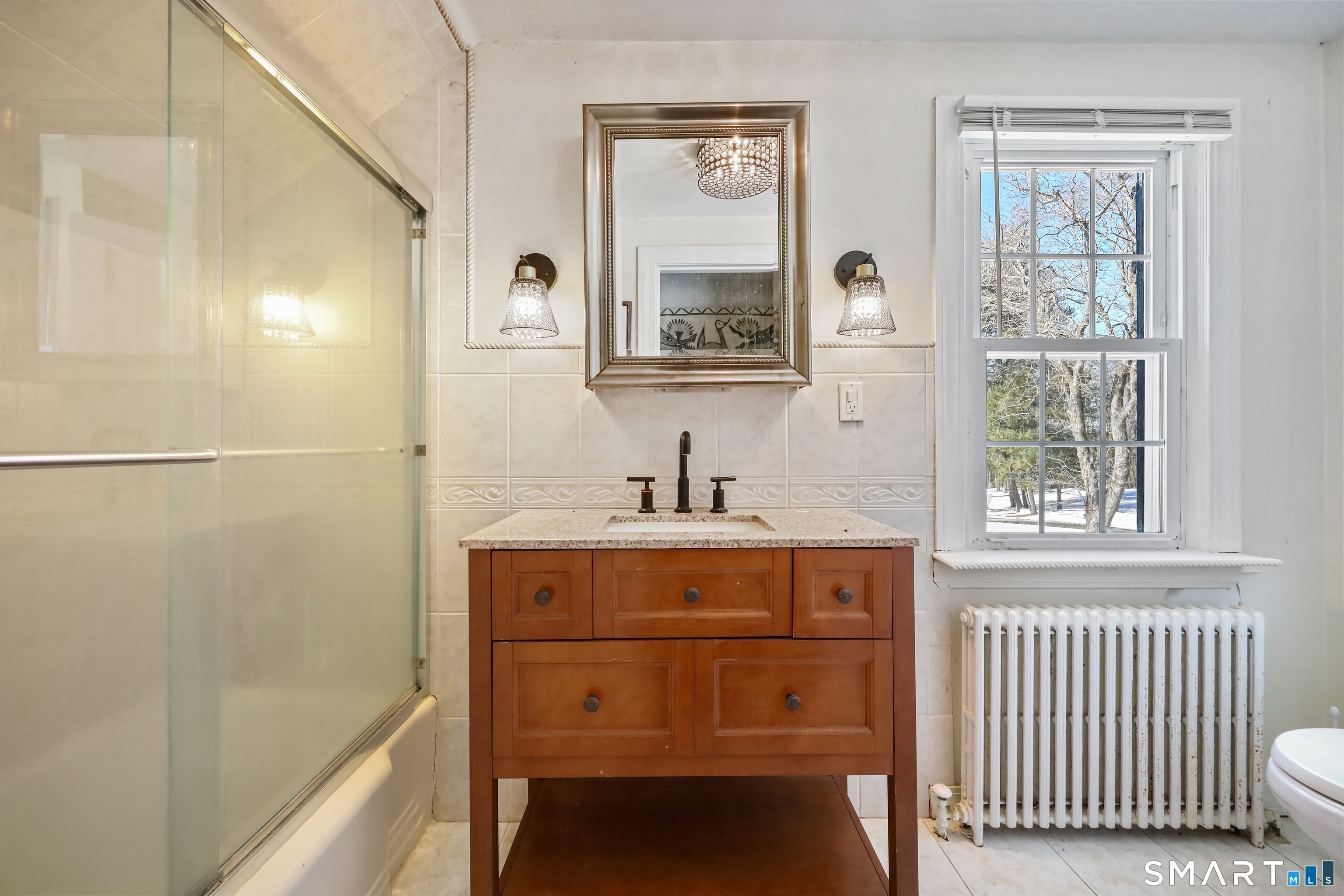 1209 Westover Road Stamford, CT 06902 - Photo 15 of 43 a bathroom with a sink a mirror and a bathtub