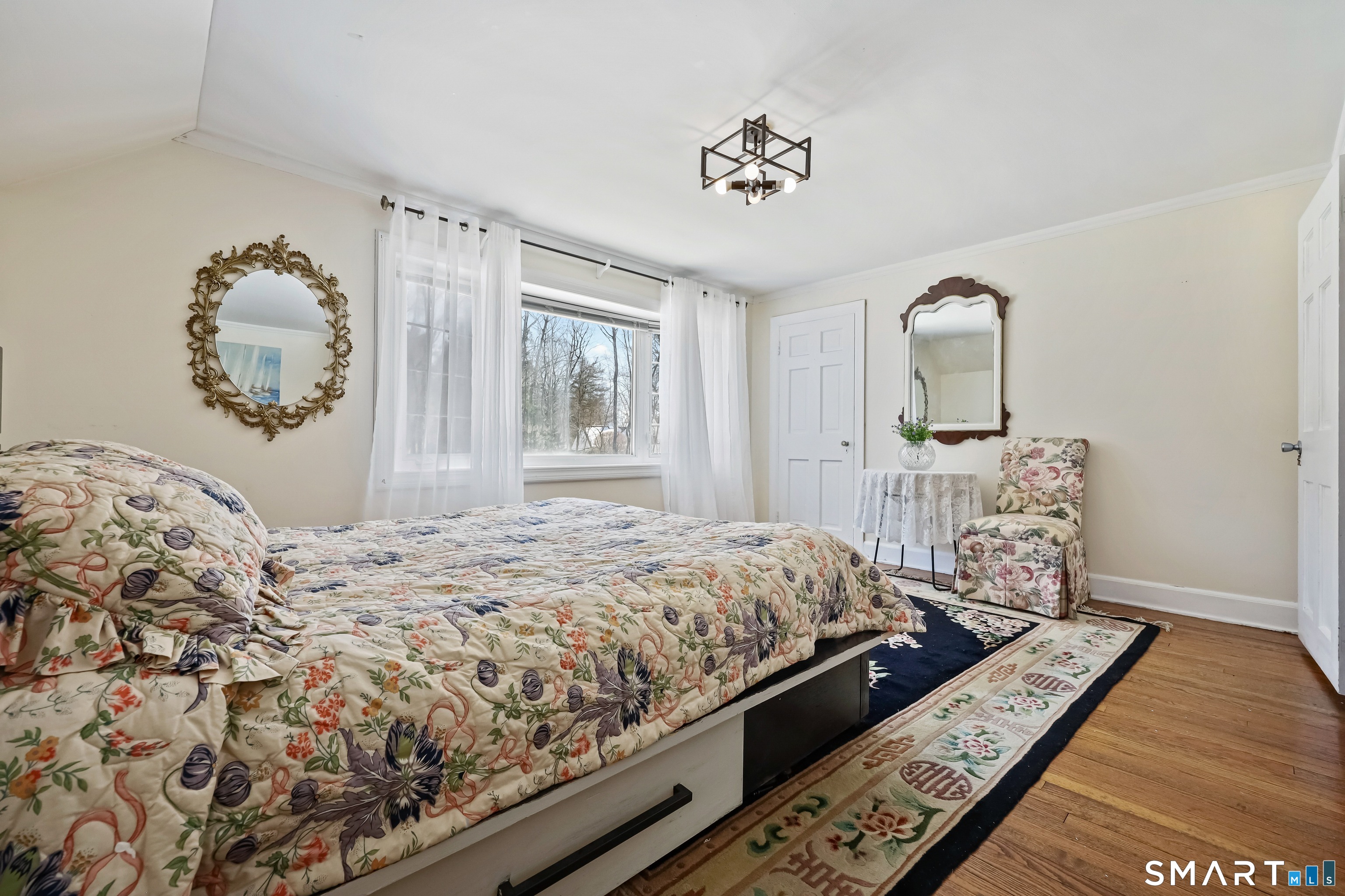 1209 Westover Road Stamford, CT 06902 - Photo 26 of 43 a bedroom with a bed and wooden floor