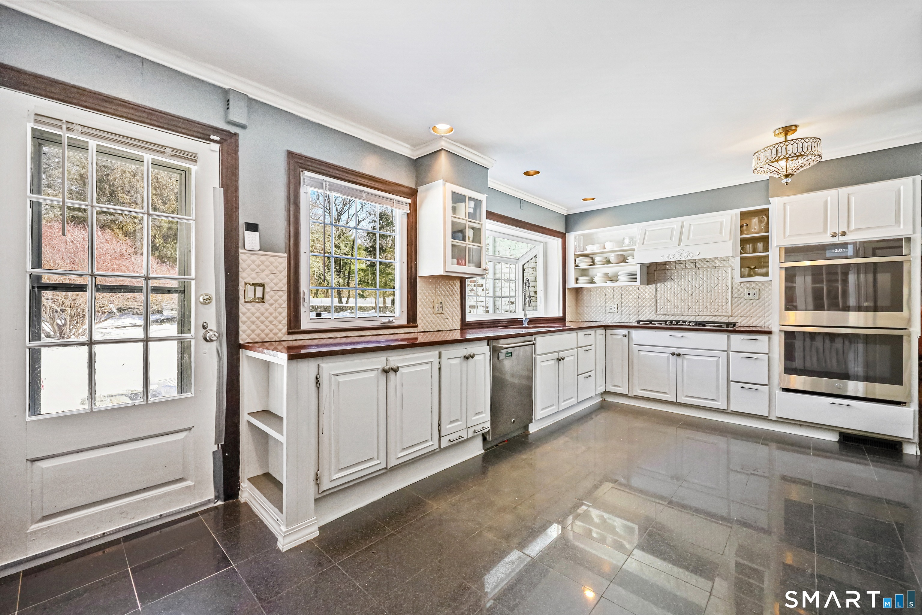 1209 Westover Road Stamford, CT 06902 - Photo 29 of 43 a kitchen with stainless steel appliances granite countertop a stove and cabinets