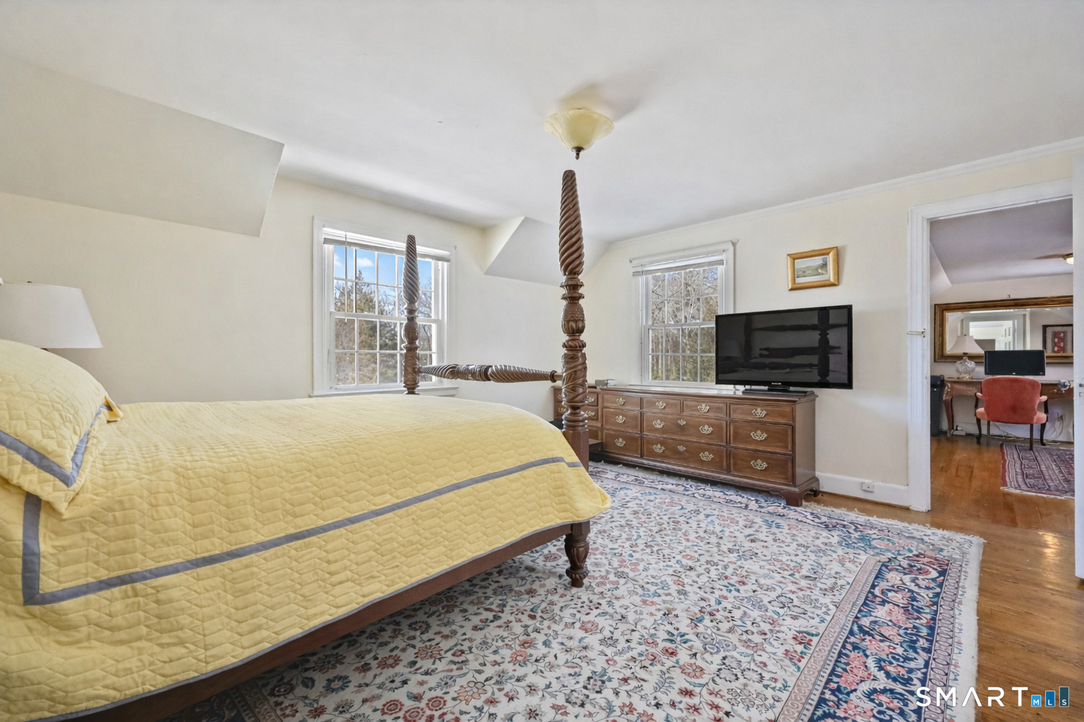 1209 Westover Road Stamford, CT 06902 - Photo 41 of 43 a bedroom with a bed a mirror on dresser and a wooden floor