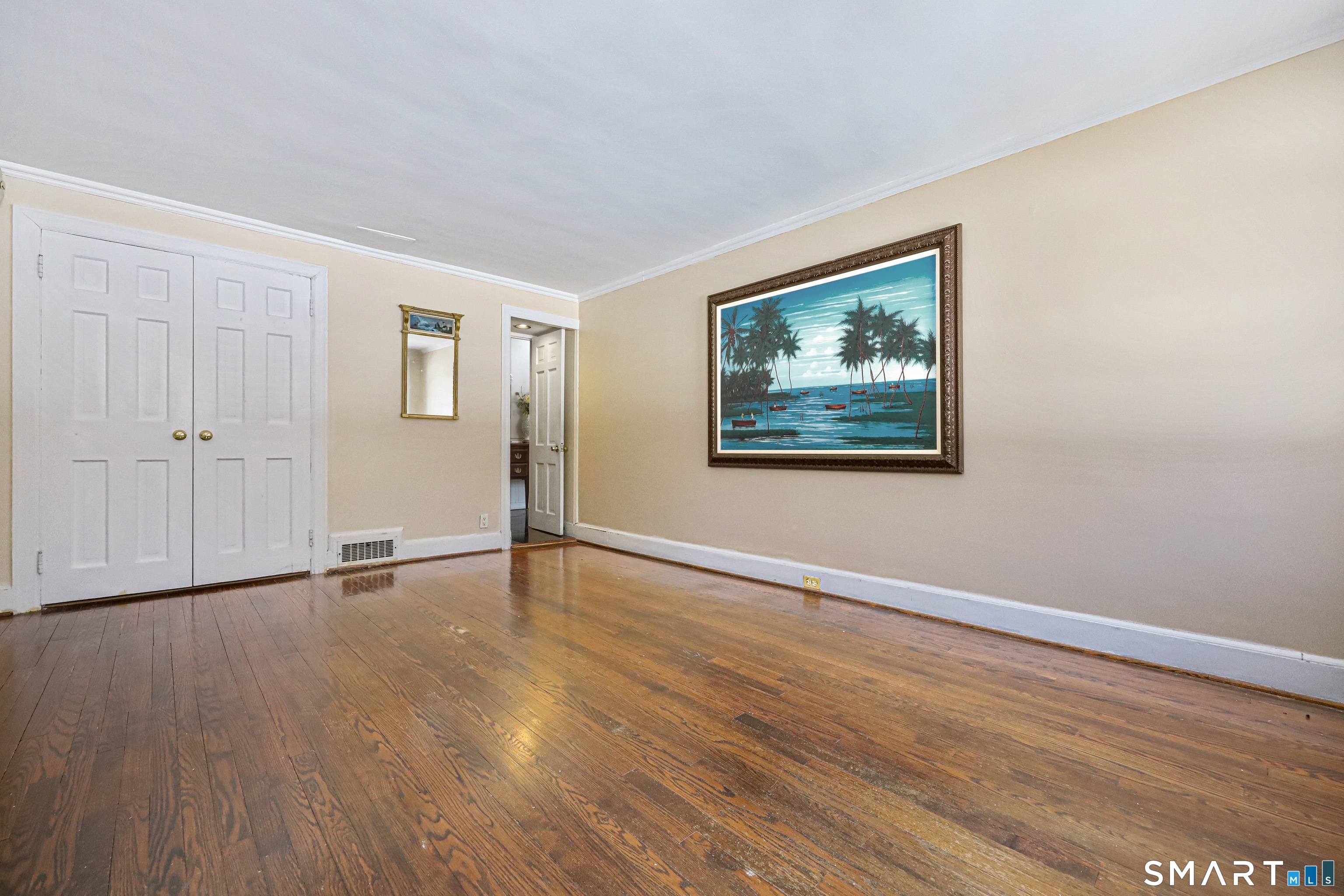 1209 Westover Road Stamford, CT 06902 - Photo 6 of 43 a view of an empty room with wooden floor and a window