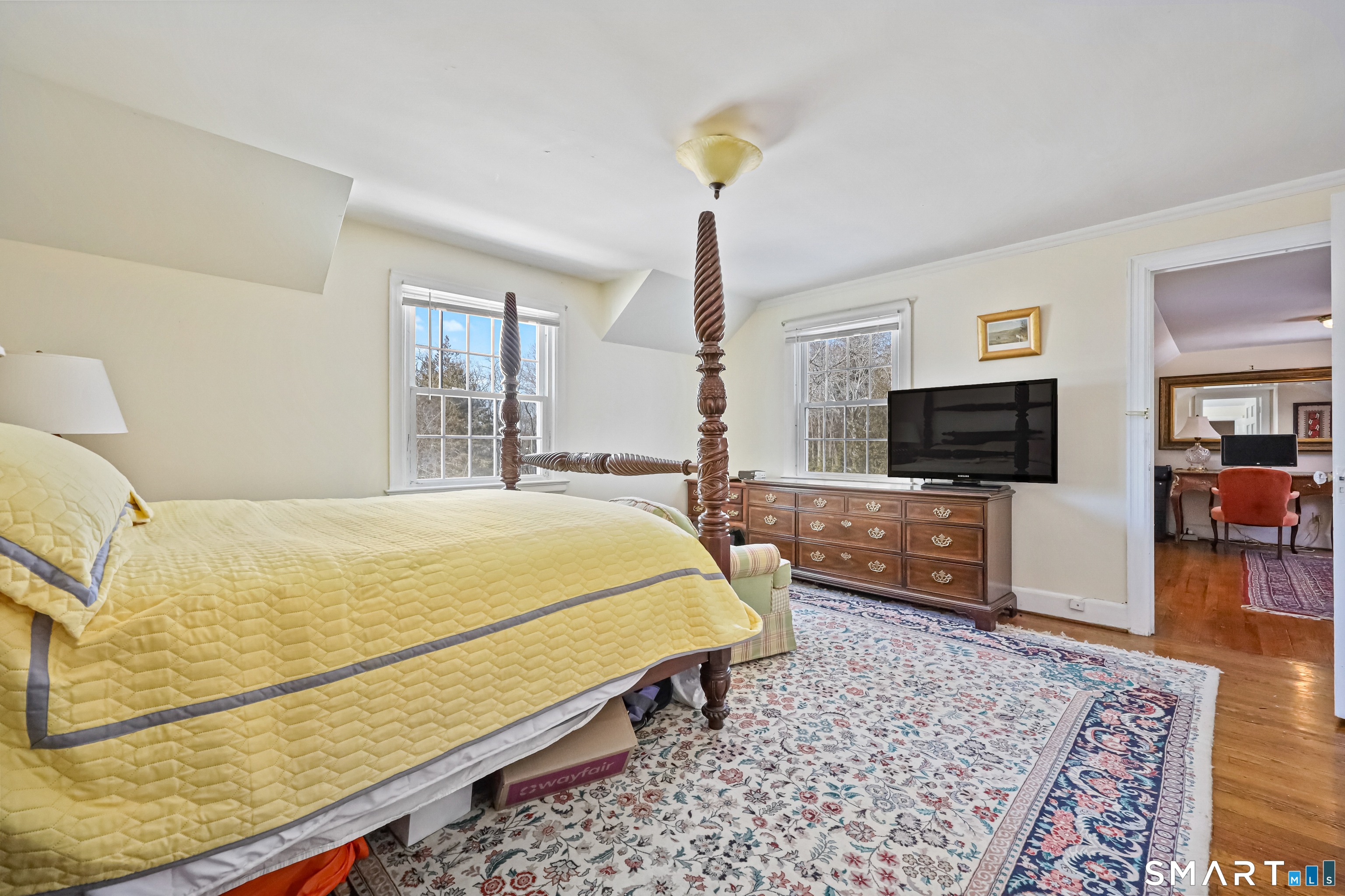 1209 Westover Road Stamford, CT 06902 - Photo 8 of 43 a bed sitting in a spacious bedroom next to a window with pc on the rug