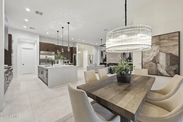 a dining room with furniture and a chandelier