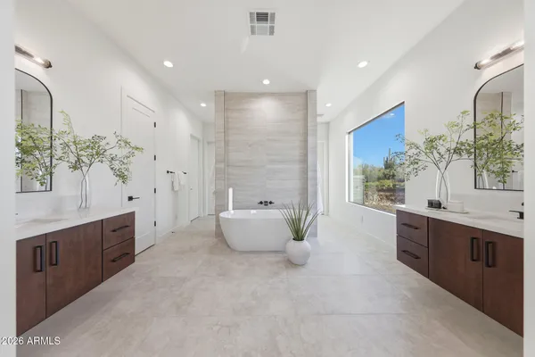 a large bathroom with a large tub sink and vanity
