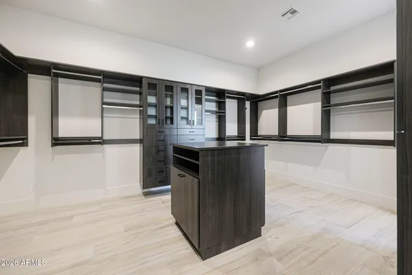 a kitchen with stainless steel appliances granite countertop a sink and a refrigerator