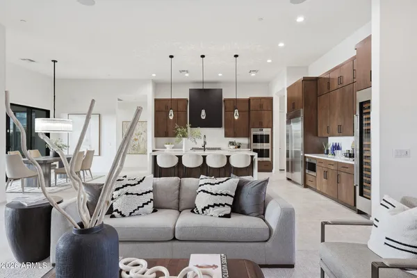 a living room with furniture and a view of kitchen