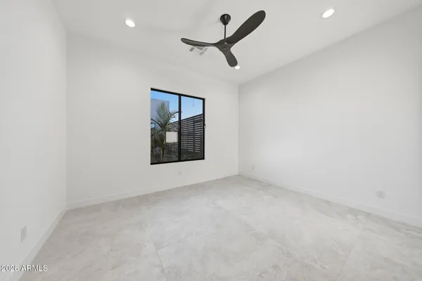 an empty room with closet and wooden floor