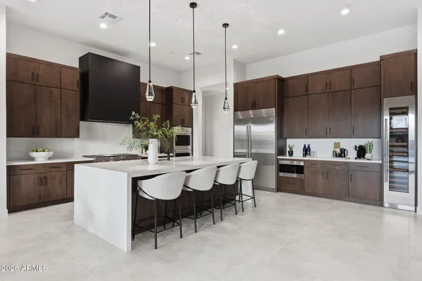 a large kitchen with a large counter top appliances and cabinets