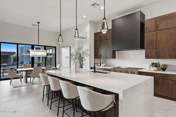 a kitchen with a table chairs stove and microwave