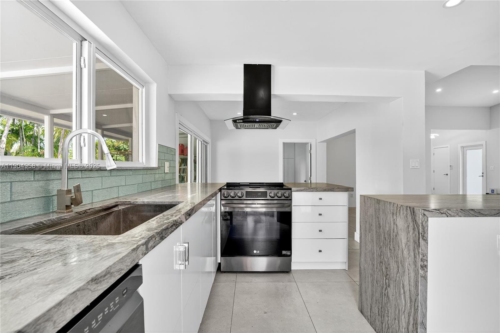 2325 Northeast 194th Street Miami, FL 33180 - Photo 11 of 36 a kitchen with a stove and a sink
