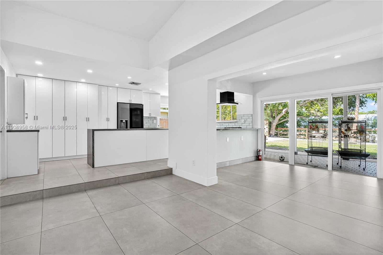 2325 Northeast 194th Street Miami, FL 33180 - Photo 12 of 36 a large white kitchen with a large window