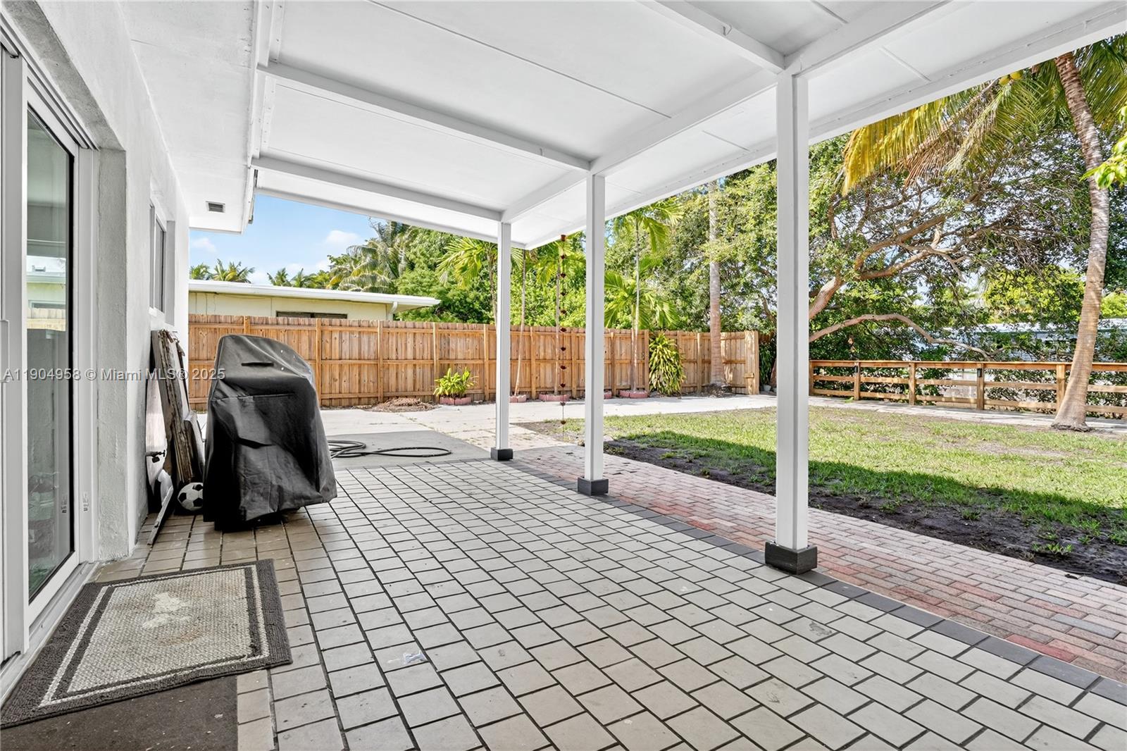2325 Northeast 194th Street Miami, FL 33180 - Photo 13 of 36 a view of a porch with chairs and backyard