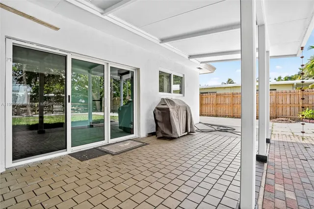 a living room with a large window and furniture