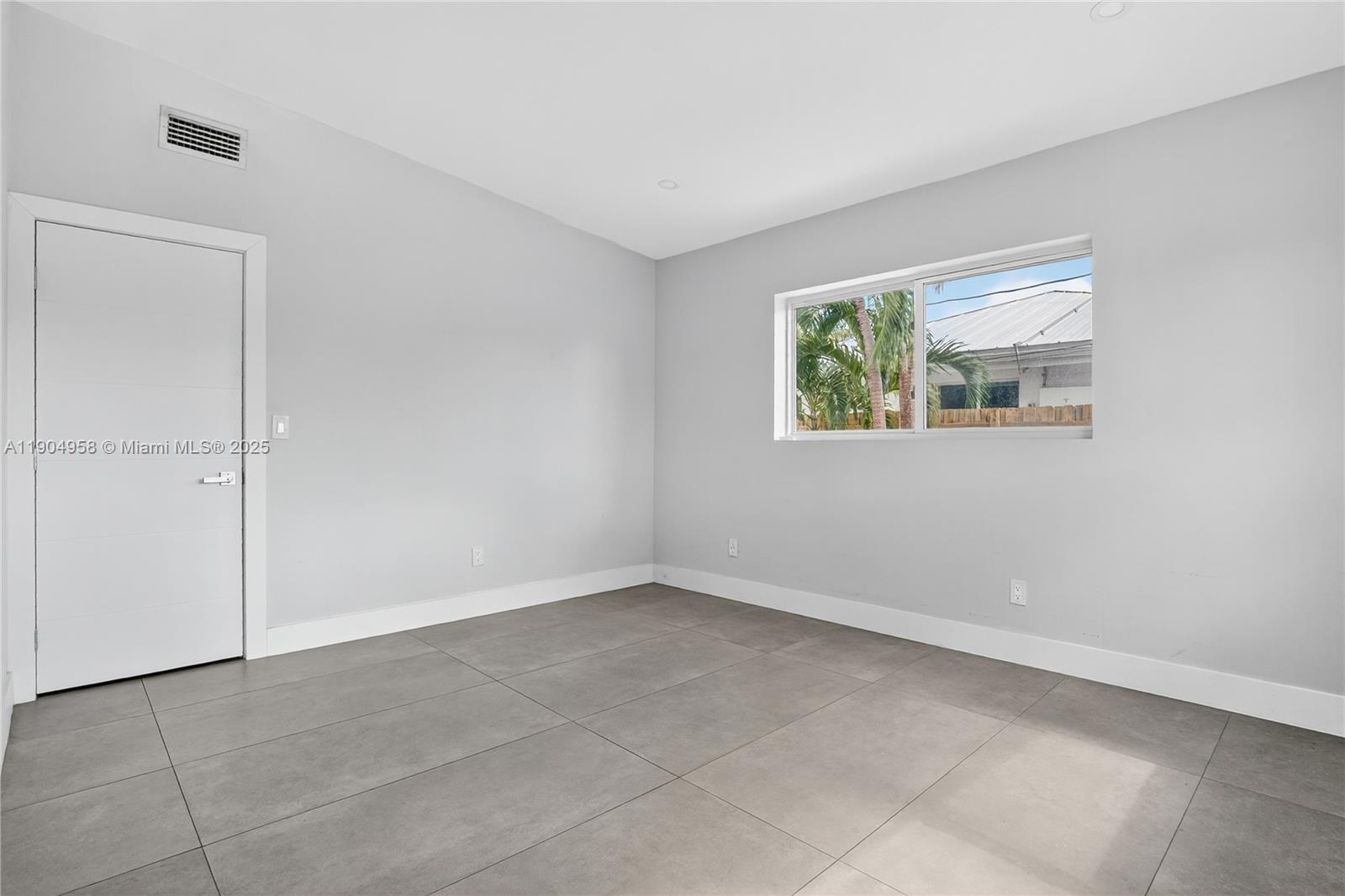 2325 Northeast 194th Street Miami, FL 33180 - Photo 16 of 36 an empty room with windows