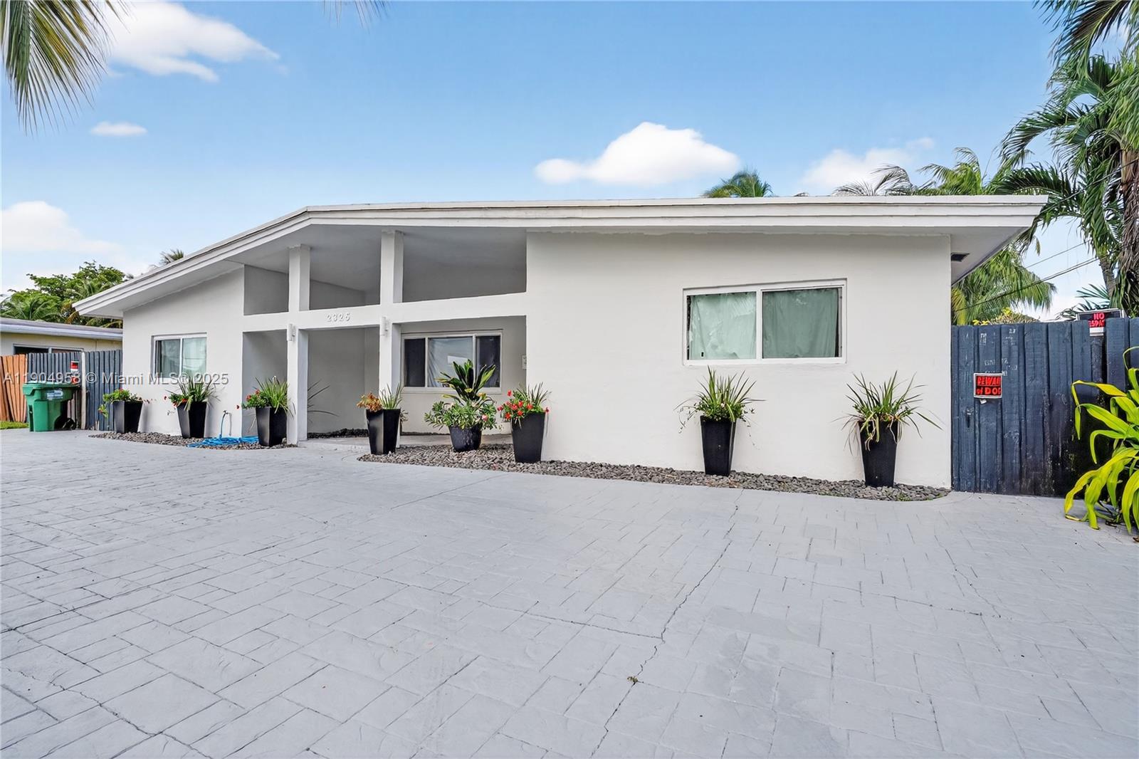 2325 Northeast 194th Street Miami, FL 33180 - Photo 2 of 36 a view of a house with a outdoor space and a car parked
