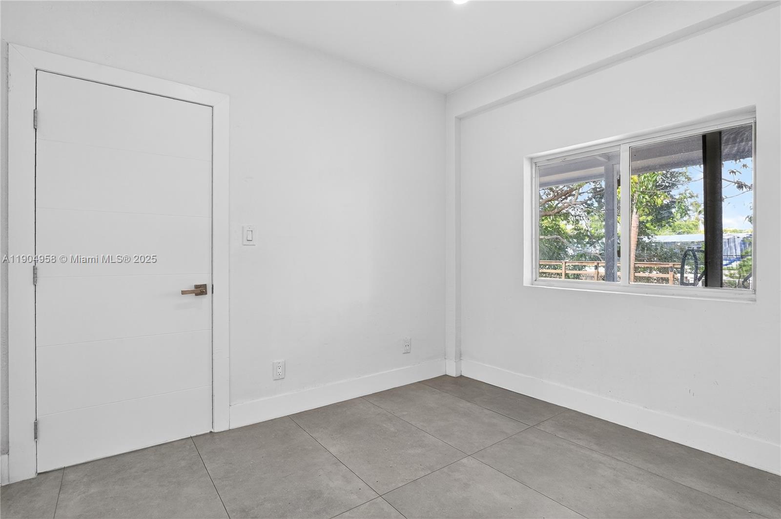 2325 Northeast 194th Street Miami, FL 33180 - Photo 21 of 36 an empty room with windows