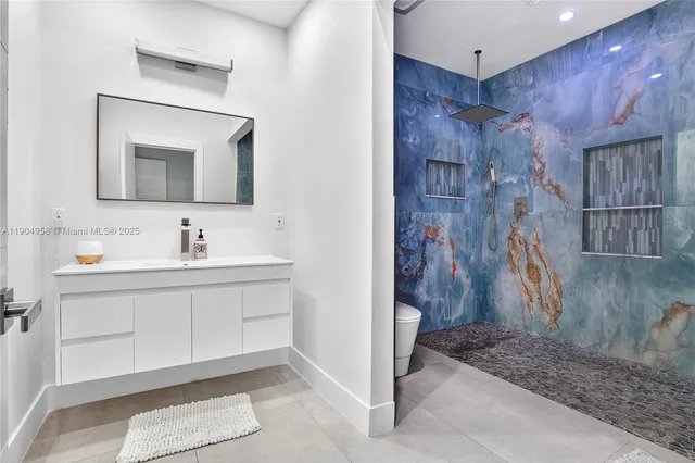 a bathroom with a sink a mirror and a shower