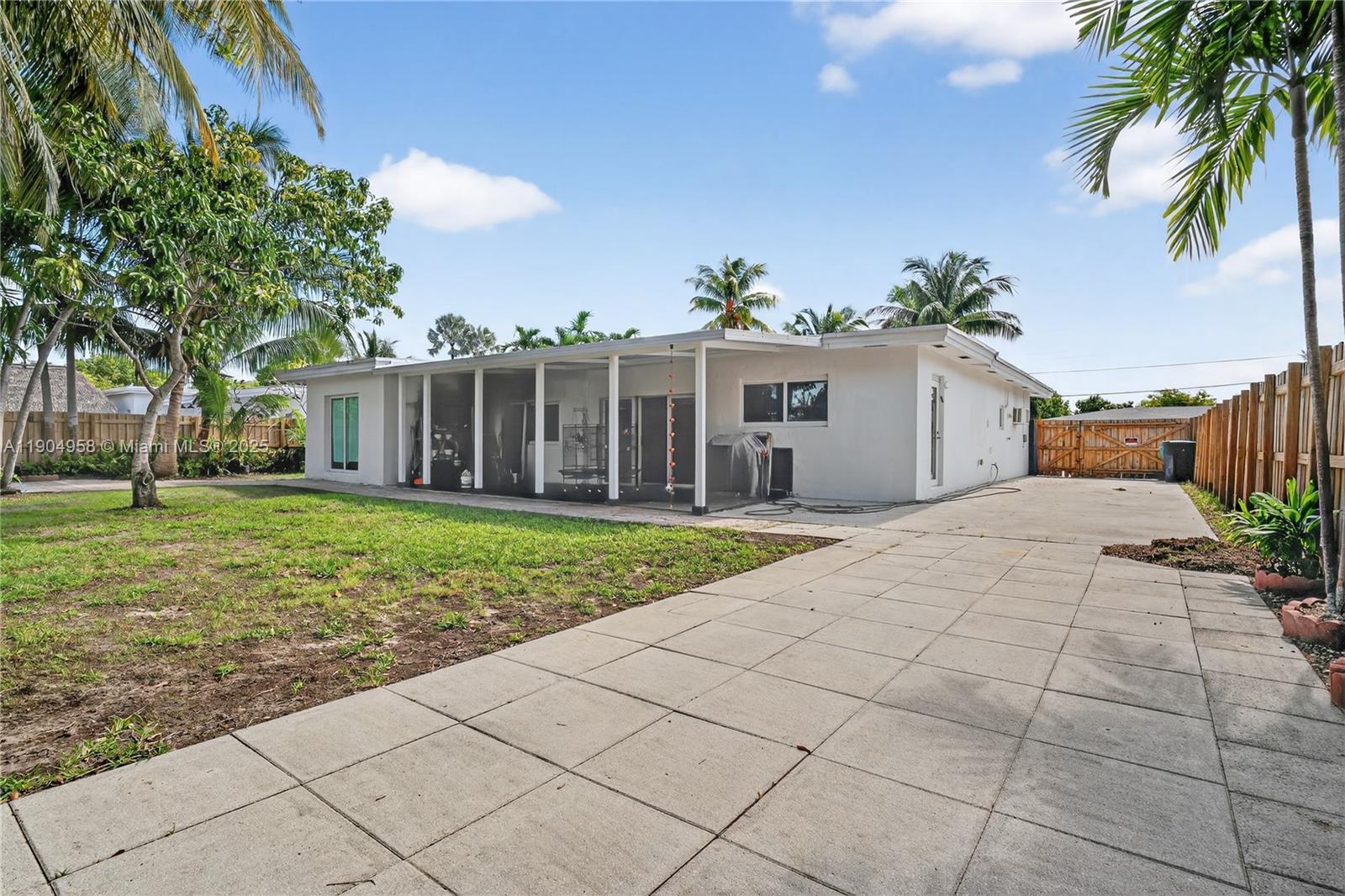 2325 Northeast 194th Street Miami, FL 33180 - Photo 30 of 36 a view of a house with a yard
