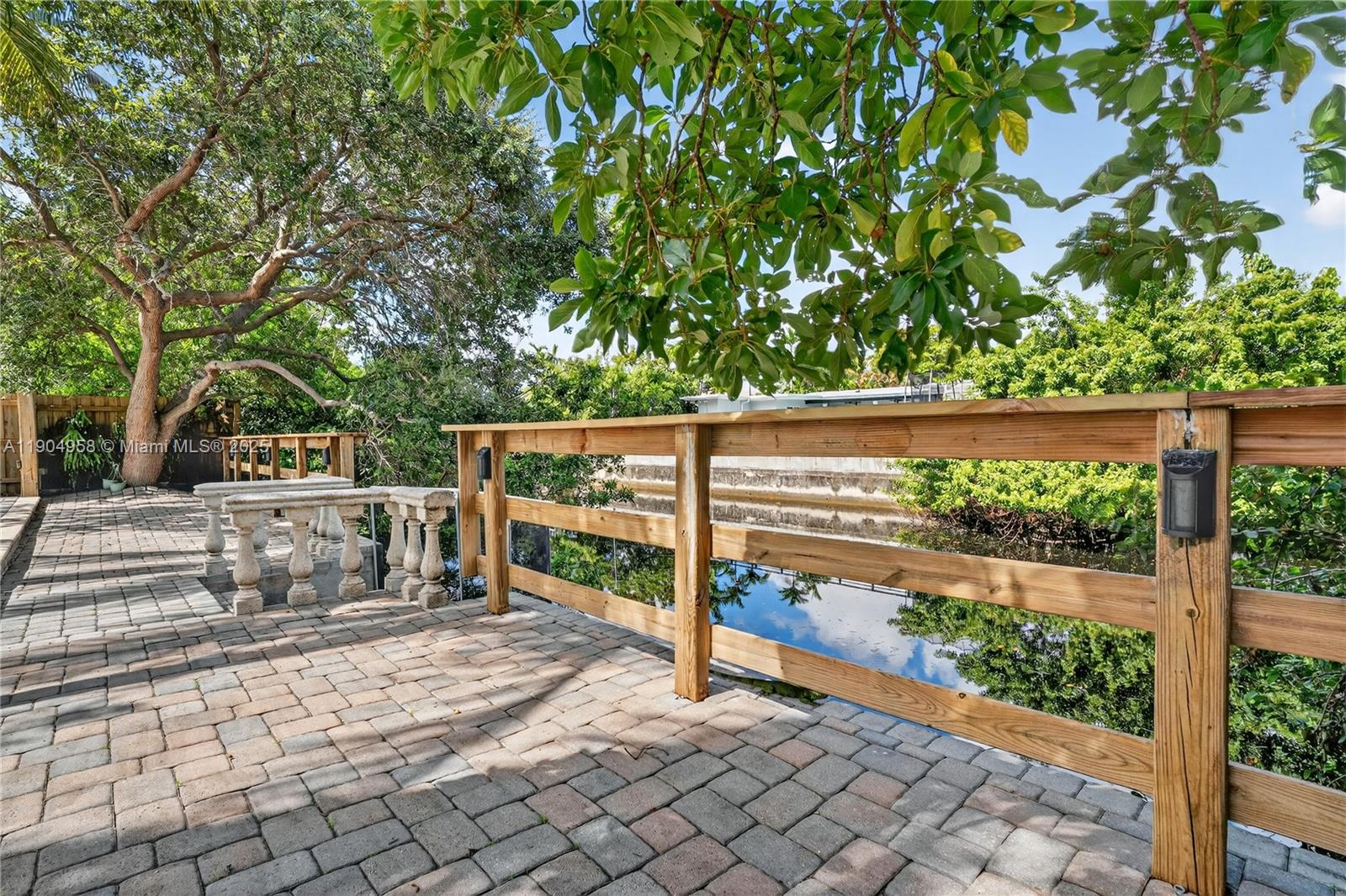 2325 Northeast 194th Street Miami, FL 33180 - Photo 31 of 36 a view of backyard with tree